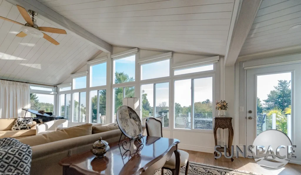 Sunroom with windows and ceiling fan