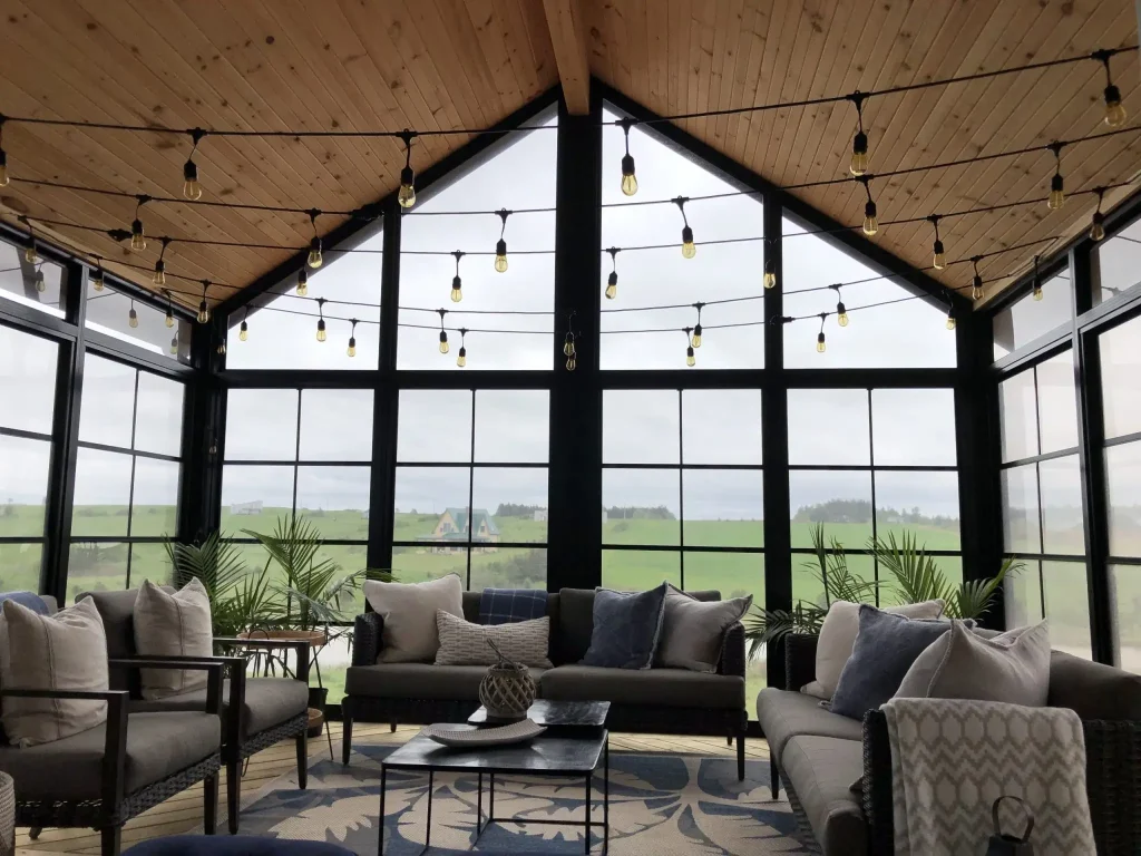Sunroom with large windows and cozy furniture in natural light