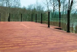 Wooden deck surrounded by a fence, showcasing an Aluminum Decking