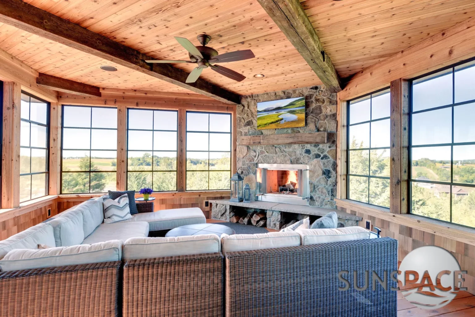 Sunroom with fireplace and large screen for relaxation