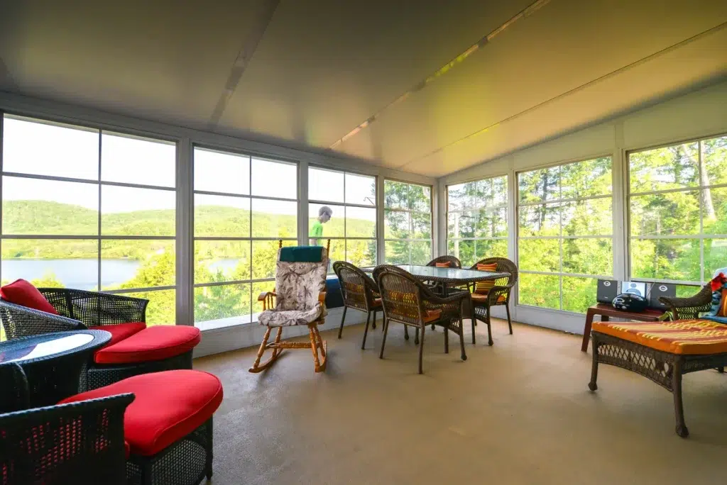 Sunlit Model 200 WeatherMaster Sunroom with table and chairs for gatherings